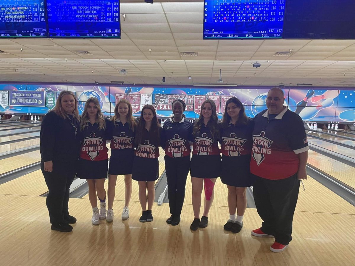 The girls bowling team poses for a photo after a match earning the MAC Red championship.
