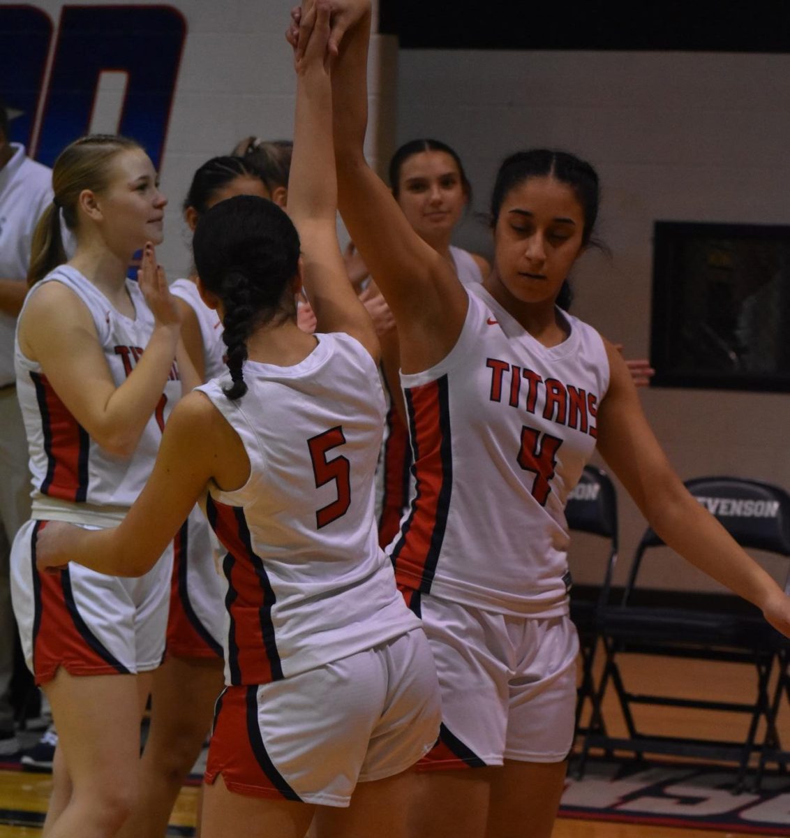 In a celebratory high five and hip bump the teamwork is seen both on and off the court. On Wednesday, Mar 5, 2025, the Sterling Heights Stevenson Varsity Girls Basketball team lost their MHSAA Division 1, District 31 at Utica Ford game against Utica Ford High School by a score of 23-78.