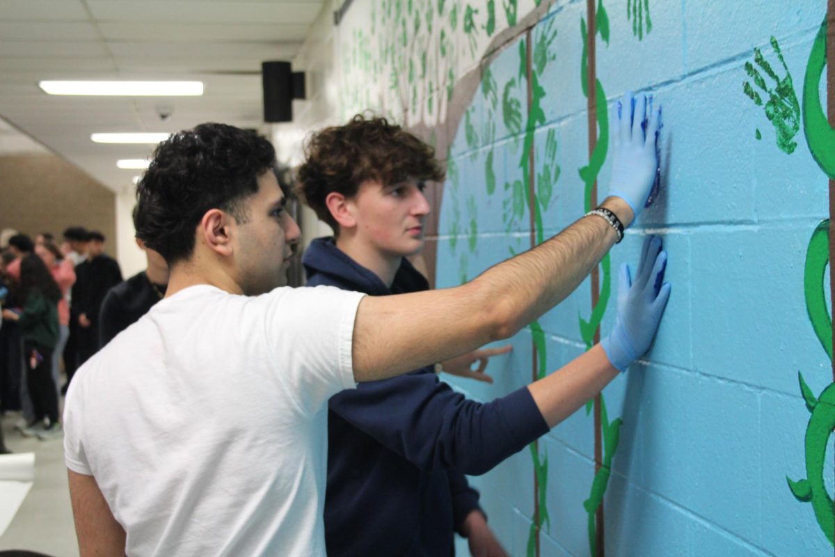 Students join together in the cafeteria to add their handprint to the senior wall. "It's a really nice event and helps
the seniors at Stevenson connect and get
closer to each other. It's a fun way to leave kind of a legacy at the school for all of us," Angelo Saleh '25 said. 
