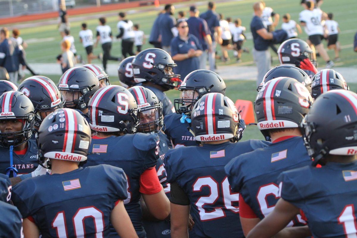 David Johnson '25 (#10) stands with his teammates before taking the field, soaking in one of his final moments as a Titan.
