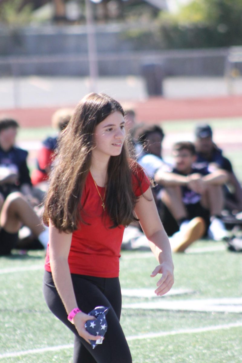 Playing cornhole against the opposing side, the teachers, Emma Behnam '27 competed during the pep rally. She performed well as her friends cheered her on from the sidelines, hoping she would gain an advantage over the teachers.