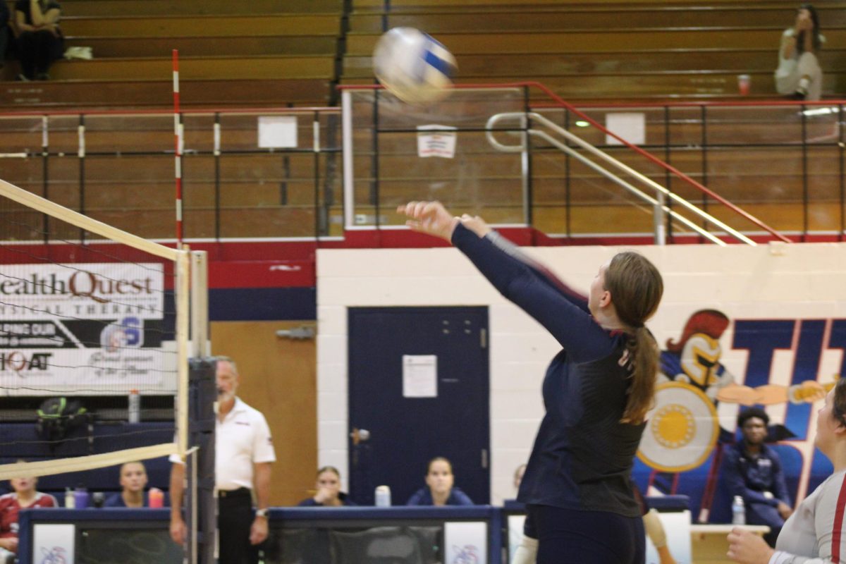 Serving the ball to the other team Delaney Clark '26 said she enjoys the competition and playing with her friends.  